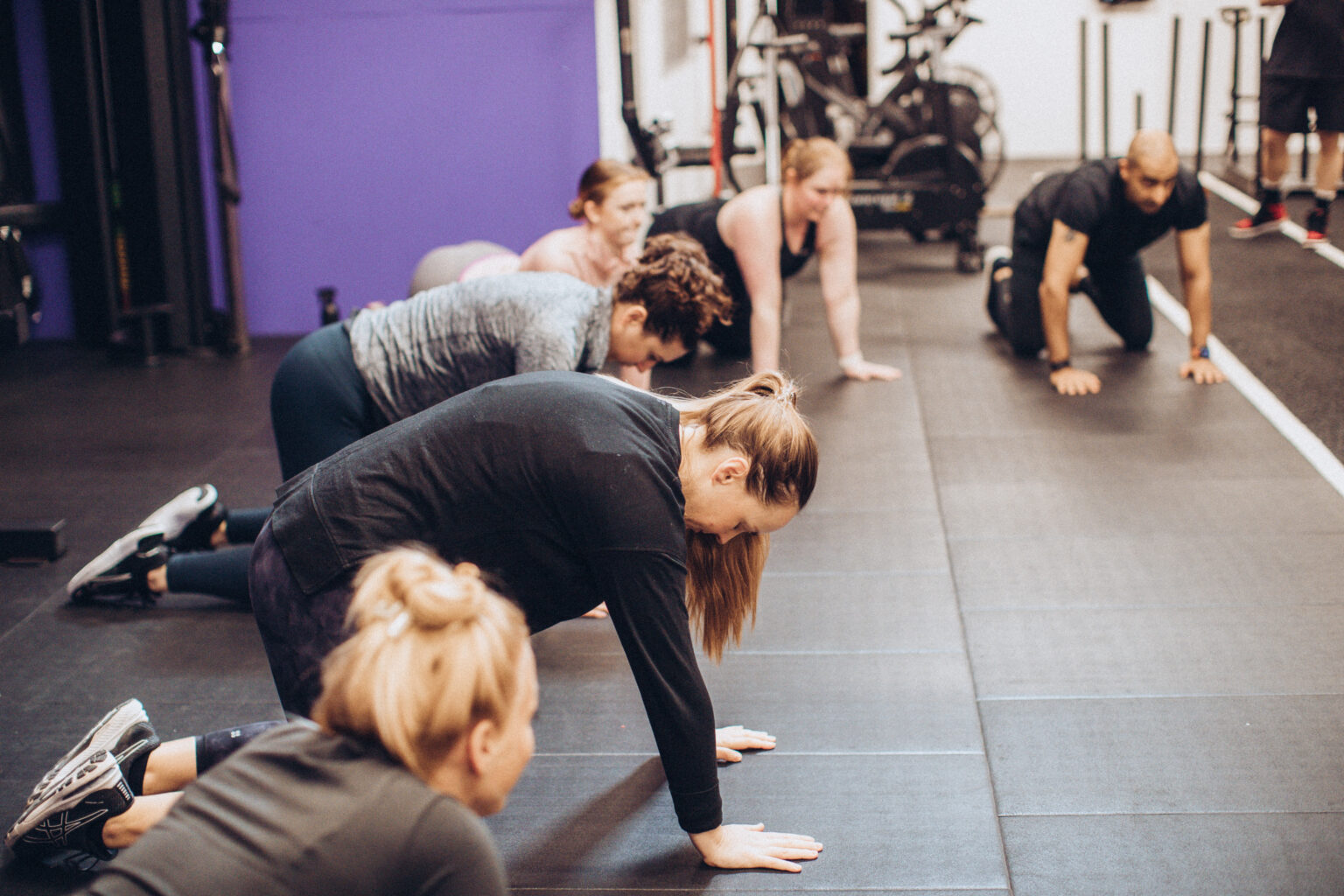 Members doing a floor exercise in a performance class