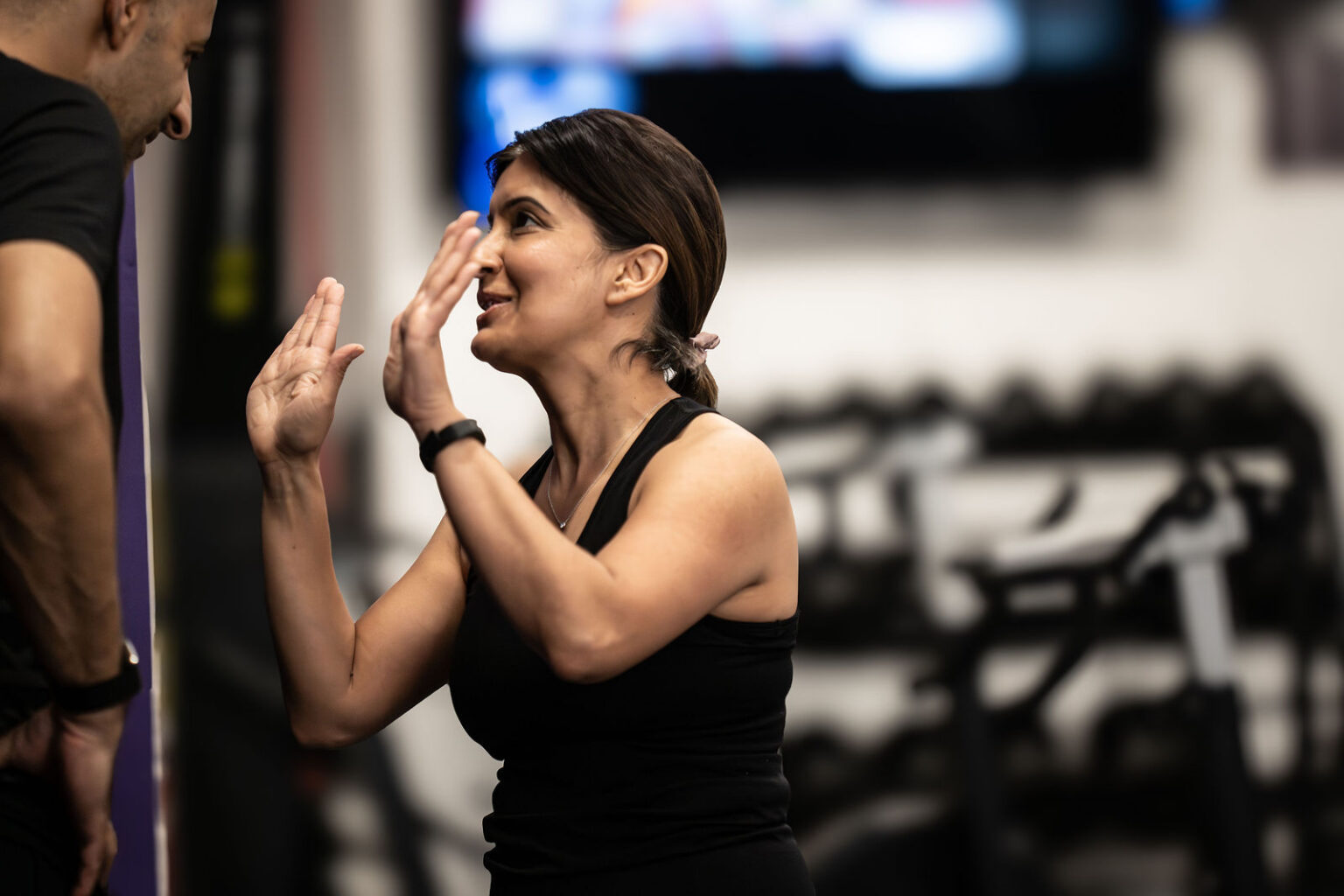 A coach high-fiving a member mid-session