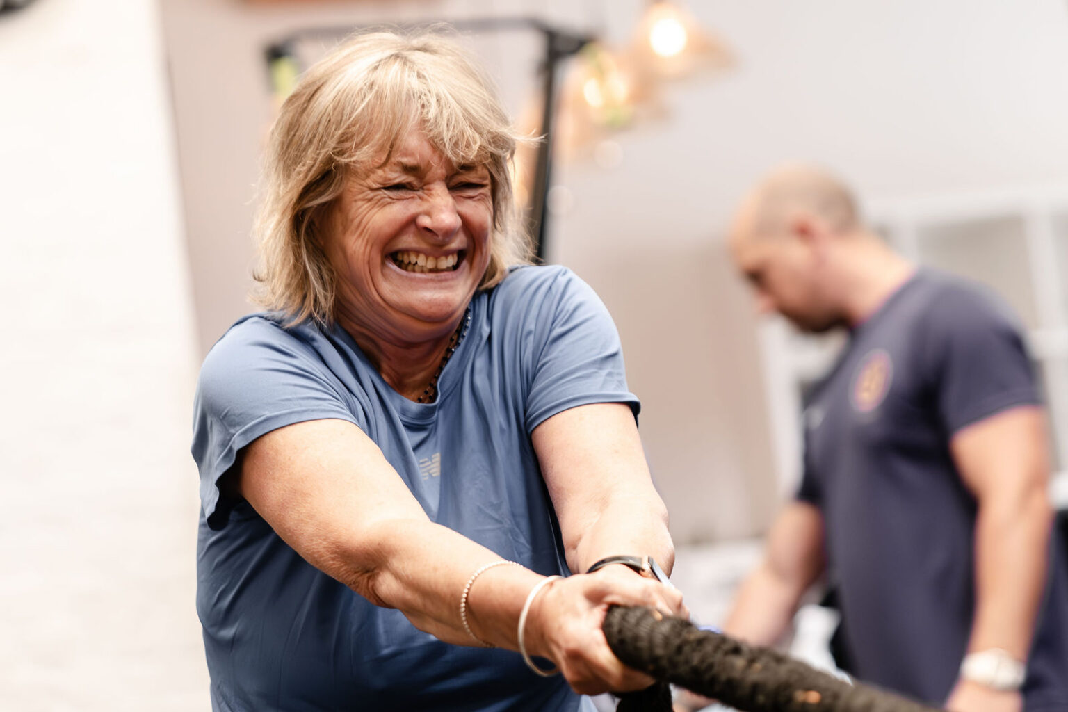 A member laughing during a rowing set