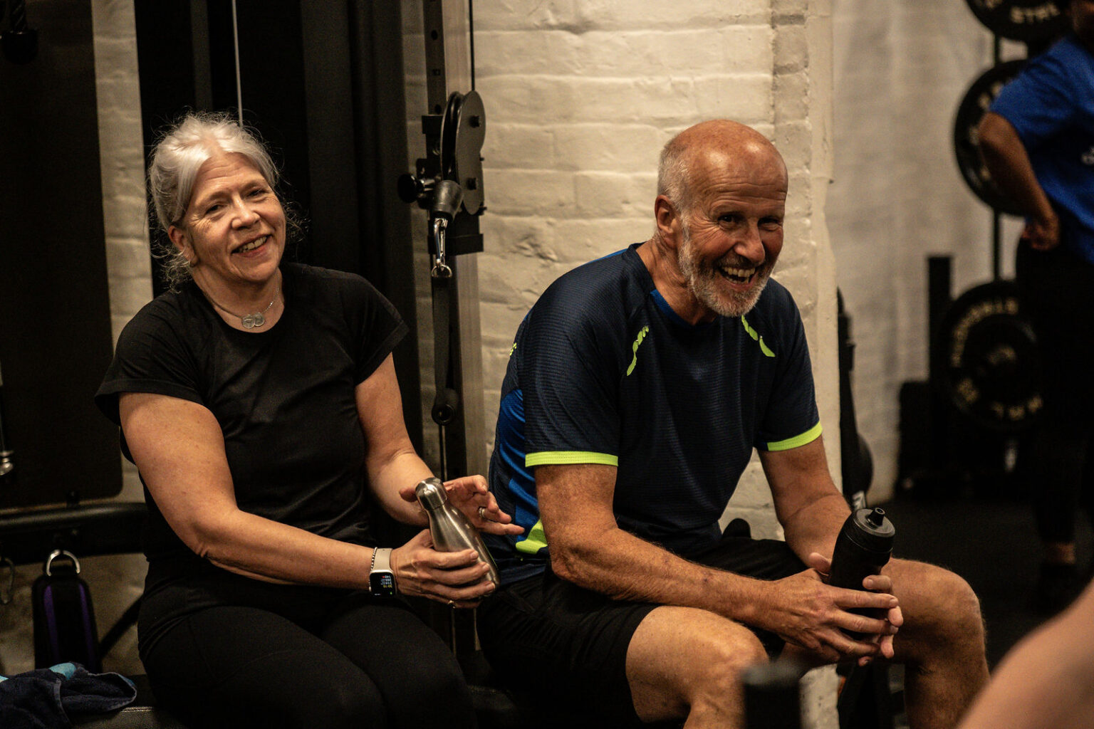 Two members laughing together between sets